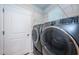 Laundry room with washer, dryer and shelving at 11922 Bristol Bridge Rd, Spring Hill, FL 34610