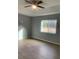 Spacious bedroom with wood-look floors and ceiling fan at 12076 Scottsboro Ave, Brooksville, FL 34614