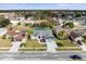 Aerial view of a house with a large yard, driveway, and neighborhood at 1230 Venetia Dr, Spring Hill, FL 34608