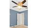 Blue-walled bedroom with ceiling fan and door at 1230 Venetia Dr, Spring Hill, FL 34608