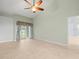Relaxing bedroom with tile floors and access to the backyard at 1230 Venetia Dr, Spring Hill, FL 34608