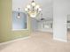 Elegant dining room with a chandelier and view to living room at 1230 Venetia Dr, Spring Hill, FL 34608