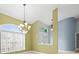 Sunlit dining area near entryway with stained glass accents at 1230 Venetia Dr, Spring Hill, FL 34608