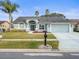 Nice curb appeal! Light blue house with a two-car garage at 1230 Venetia Dr, Spring Hill, FL 34608