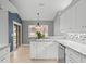 Open kitchen with white cabinets, granite counters, and island at 1230 Venetia Dr, Spring Hill, FL 34608