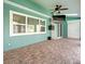 Covered patio with tile floor, ceiling fan, and TV at 1230 Venetia Dr, Spring Hill, FL 34608