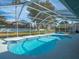 Relax and enjoy this kidney-shaped pool with a screened enclosure at 1230 Venetia Dr, Spring Hill, FL 34608