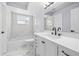 Modern bathroom with white vanity, marble floors, and shower/tub at 13124 Lawrence St, Spring Hill, FL 34609
