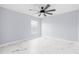 Well-lit bedroom with ceiling fan and marble-look floors at 13124 Lawrence St, Spring Hill, FL 34609