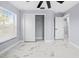 Bright bedroom with window, closet, and marble-look floors at 13124 Lawrence St, Spring Hill, FL 34609