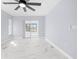 Light-blue bedroom with marble floors and access to sunroom at 13124 Lawrence St, Spring Hill, FL 34609