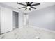 Bedroom with double-door closet, ceiling fan, and marble floors at 13124 Lawrence St, Spring Hill, FL 34609