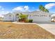 White one-story house with a two-car garage and landscaped yard at 13124 Lawrence St, Spring Hill, FL 34609