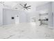 Open concept living room with marble floors and access to kitchen at 13124 Lawrence St, Spring Hill, FL 34609