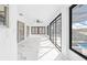 Bright sunroom with pool view, wicker furniture, and marble floors at 13124 Lawrence St, Spring Hill, FL 34609