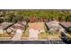 Aerial view of a house and neighborhood with surrounding trees at 13793 Dunwoody Dr, Spring Hill, FL 34609