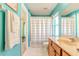 Bathroom with teal walls, wood vanity, and shower curtain at 13793 Dunwoody Dr, Spring Hill, FL 34609