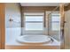 Bathroom features a large garden tub and glass shower enclosure at 13793 Dunwoody Dr, Spring Hill, FL 34609