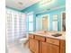 Teal bathroom with a vanity, toilet and shower/tub combo at 13793 Dunwoody Dr, Spring Hill, FL 34609