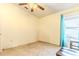 Bright bedroom with ceiling fan, neutral walls, and teal curtains at 13793 Dunwoody Dr, Spring Hill, FL 34609