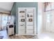 Living area with built-in white shelves and hardwood floors at 13793 Dunwoody Dr, Spring Hill, FL 34609