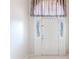 White front door with sidelights and decorative window valance at 13793 Dunwoody Dr, Spring Hill, FL 34609