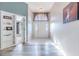 Bright entryway with white door, built in shelving, and wood-look flooring at 13793 Dunwoody Dr, Spring Hill, FL 34609
