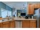 Kitchen with wood cabinets, stainless steel appliances, and a breakfast bar at 13793 Dunwoody Dr, Spring Hill, FL 34609