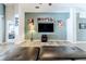 Spacious living room with large TV, hardwood floors, and comfortable seating at 13793 Dunwoody Dr, Spring Hill, FL 34609