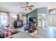 Spacious living room with a ceiling fan, cowhide rug, and built-in shelving at 13793 Dunwoody Dr, Spring Hill, FL 34609