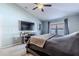Main bedroom with large TV and access to balcony at 13793 Dunwoody Dr, Spring Hill, FL 34609