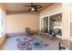Covered patio with seating area and view to backyard at 13793 Dunwoody Dr, Spring Hill, FL 34609
