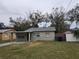 Light green house with a carport and a fenced yard at 1605 E Maple Ave, Tampa, FL 33604