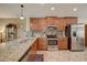 Spacious kitchen with granite countertops and stainless steel appliances at 18732 Dobson Dr, Hudson, FL 34667