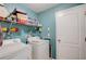 Laundry room with washer, dryer and shelving at 18732 Dobson Dr, Hudson, FL 34667