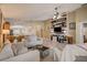 Living room with a wood accent wall and neutral colored sofas at 18732 Dobson Dr, Hudson, FL 34667