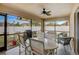 Relaxing screened porch with patio furniture and ceiling fan at 18732 Dobson Dr, Hudson, FL 34667