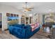 Living room with a blue sectional sofa and views to the dining area at 2510 Whitewood Ave, Spring Hill, FL 34609