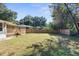 Large backyard with green grass and wooden fence at 26369 Eahnestock St, Brooksville, FL 34602