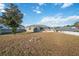 Large backyard with mature tree and firepit area at 3110 Lema Dr, Spring Hill, FL 34609