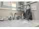 Bathroom with marble countertop, modern faucet, and updated vanity at 3110 Lema Dr, Spring Hill, FL 34609