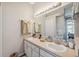 Double vanity bathroom with updated fixtures and a large mirror at 3110 Lema Dr, Spring Hill, FL 34609