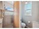 Bathroom features a walk-in shower, toilet, and window at 3110 Lema Dr, Spring Hill, FL 34609