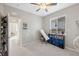 Bright bedroom with ceiling fan, window, and built-in shelving at 3110 Lema Dr, Spring Hill, FL 34609