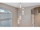 Entryway with a modern light fixture and window with blinds at 3110 Lema Dr, Spring Hill, FL 34609