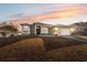 One-story house with a light-brown exterior, a two-car garage, and a neatly landscaped lawn at 3110 Lema Dr, Spring Hill, FL 34609