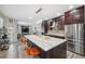 Kitchen with island, stainless steel appliances, and a view into the living room at 3110 Lema Dr, Spring Hill, FL 34609