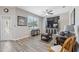 Spacious living room with hardwood floors and large TV at 3110 Lema Dr, Spring Hill, FL 34609