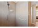 Walk-in shower with grab bar and neutral tile at 3110 Lema Dr, Spring Hill, FL 34609