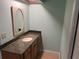 Bathroom with granite countertop and oval mirror at 3151 Carlos Dr, Dunedin, FL 34698